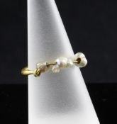 A Roman gold hoop earring mounted with three baroque pearls.