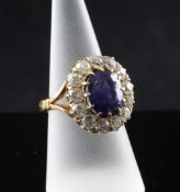 A 1990`s 14ct gold, synthetic sapphire and diamond set oval cluster dress ring, with pierced