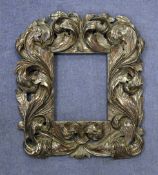 A 17th century stained limewood picture frame, carved with acanthus leaf scrolls, 20 x 17in.
