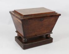 A 19th century mahogany wine cooler, stepped lid and tapered body with quarter cotton reel
