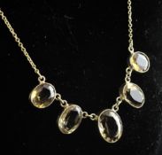 A 9ct gold and citrine drop necklace, set with five graduated oval cut stones, 16.25in.