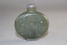 A Chinese green jade snuff bottle, carved in low relief with a bird amid prunus, 5cm., stopper