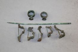 Five Roman bronze fibula brooches, two seal top rings and a tool, 1st-2nd century A.D.