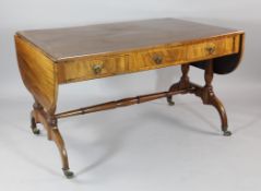 A Regency mahogany sofa table, with an arrangement of frieze drawers and dummy drawers, on twin