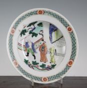 A Chinese famille verte soup dish, painted with figures in a pavilion garden, flower and diaper