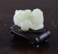 A Chinese white jade group of two lion-dog cubs, 18th / 19th century. each biting a sprig of