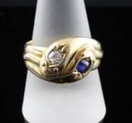 A late Victorian 18ct gold, diamond and sapphire set twin serpent ring, the old cut diamond weighing