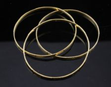 A set of three middle eastern 21ct gold bangles, with bright cut decoration, maker, MB, 26.1 grams.