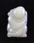 A Chinese pale celadon jade figure of a boy holding a sprig of lotus, 18th / 19th century, approx.