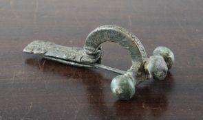 A large Roman bronze crossbow brooch, 2nd/3rd century A.D., with three onion shaped finials and cast