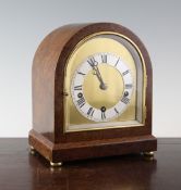 A burr walnut cased chiming mantel clock, with gilt arched brass dial and W&H movement striking on