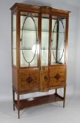 A Edwardian mahogany and inlaid display cabinet on stand, with central bow glass section between two