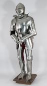 A reproduction Greenwich type steel suit of armour, with accompanying sword and stand, 6ft 2in.
