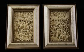 A pair of Chinese ivory panels, 19th century, carved in high relief with figures amid pavilions