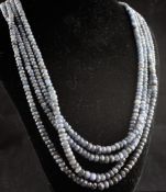An Indian? four strand facet cut sapphire necklace, with rope and tassel terminals, 30in.
