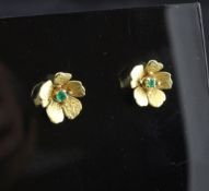 A pair of 1970`s 18ct gold and emerald set flower head earrings.