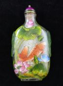 A Chinese enamelled glass snuff bottle, painted with carp amid a lotus pond, with green overlaid