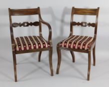 A set of six Regency mahogany dining chairs, with gadrooned spar backs and drop in seats, one with