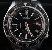 A gentleman`s modern stainless steel Grand Seiko spring drive GMT wrist watch, the black dial with