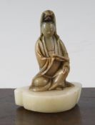 A Chinese cream coloured soapstone figure of Guanyin, 17th / 18th century, holding a scroll in her