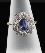 An 18ct gold, sapphire and diamond oval cluster ring, total diamond weight approximately 1.45ct,