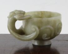 A Chinese green jade `dragon` cup, 17th century, the circular bowl carved in high relief with an