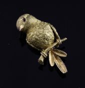 A Van Cleef & Arpels 18ct gold brooch, modelled as a bird perched on a branch, with textured