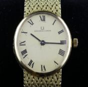 A lady`s 18ct gold Universal manual wind wrist watch, with oval Roman dial, on integral 18ct gold
