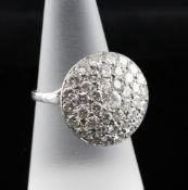 An 18ct white gold pave set diamond cluster ring, of circular form with pierced cage setting, size