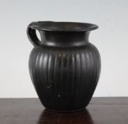 A large Greek black-glazed olpe, Southern Italy, c. 4th century B.C., with ribbed ovoid body, 5.5in.