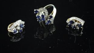 A 14ct gold sapphire and diamond dress ring, of scrolling design and a pair of similar ear clips,