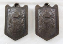 A pair of Queen Anne bronze 7lb wool weights, decorated with the Royal coat of arms and cypher AR,