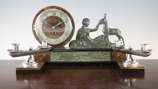 A French Art Deco bronze and marble mantel timepiece, decorated with a woman and two deer, signed