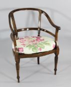 An 18th century French walnut tub chair, with cane seat, on part fluted baluster legs some old