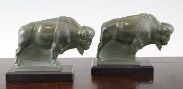 Max Le Verrier. A pair of green patinated bronze bookends, modelled as bison, on black marble