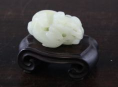 A Chinese white jade group of a lion-dog and cub, 18th / 19th century, both in curled recumbent