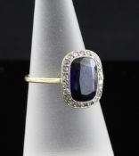 A gold, synthetic sapphire and diamond set dress ring, the central rectangular cut stone bordered