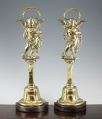 A pair of brass and cast iron door porters, each modelled with cupids, 18in.