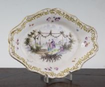 A Hochst faience lozenge shaped dish, mid 18th century, painted with a courting couple walking in