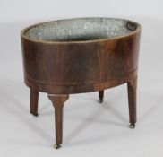 A George III flame mahogany oval wine cooler, with zinc liner, W.2ft 3in.