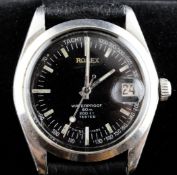 A gentleman`s 1950`s steel Tudor military wrist watch, with black dial inscribed "Rolex", with baton