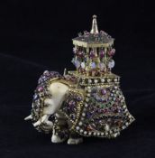 An early 20th century bejewelled silver gilt and ivory model of an elephant, with hexagonal temple