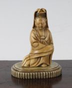 A Chinese soapstone seated figure of Guanyin, 17th / 18th century, the creamy coloured stone with