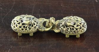 A Chinese gilt bronze `dragon` belt buckle, early 19th century, in two parts, each cast in relief