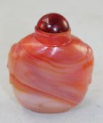 A Chinese agate glass snuff bottle, with moulded mask handles, 6.7cm.