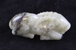 A Chinese grey and black jade figure of a recumbent ram, 3in.