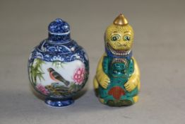Two Chinese porcelain snuff bottles, the first painted in famille rose enamels with a bird amid