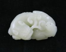 A Chinese pale celadon jade group of a lion-dog and cub, 18th / 19th century, both recumbent and