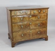 An early 18th century walnut chest, of two short and three long drawers, with featherbanded inlay,