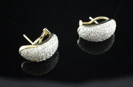 A pair of 14ct gold and pave diamond set ear clips, of concave form.